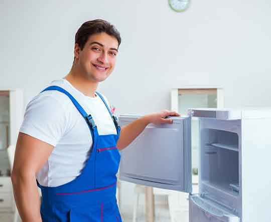 man fixing a fridge