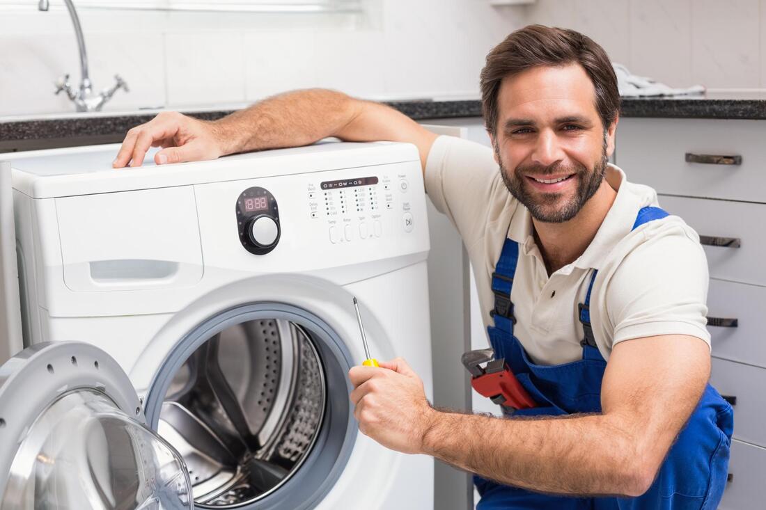 man fixing a washer